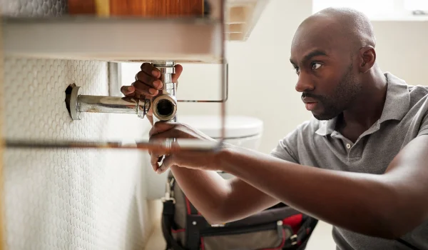 a male plumber fixing a pipe connection from Emergency Plumber Kyle in Kyle, TX 